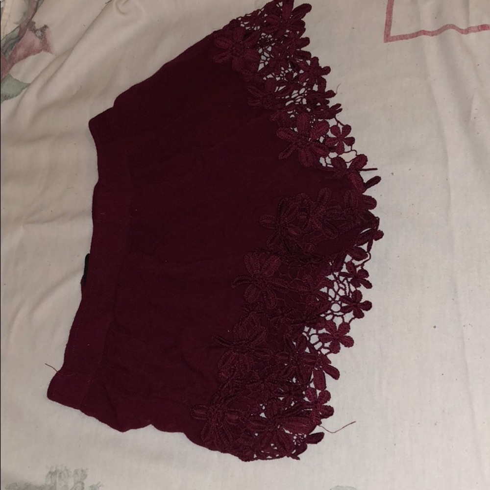 burgundy shorts.